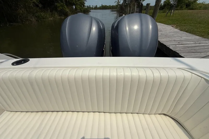 Slide: The Image of 1999 Grady-White Marlin 300 boat with twin outboard motors at a dock. - 13