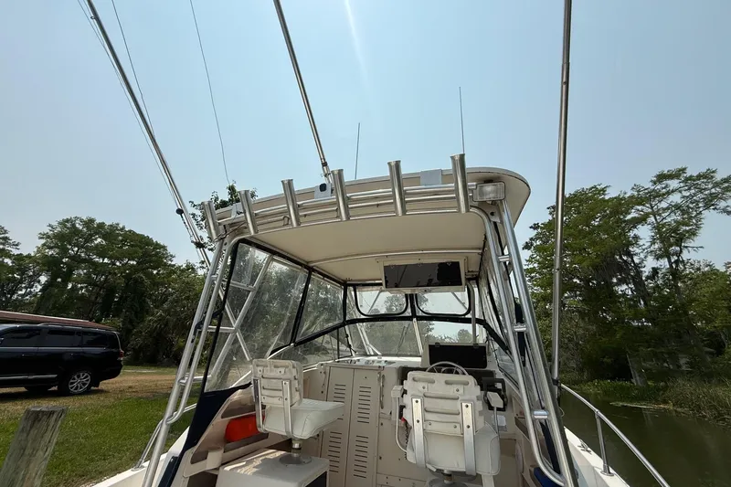 Slide: The Image of 1999 Grady-White Marlin 300 boat cockpit with fishing rod holders and seating. - 15