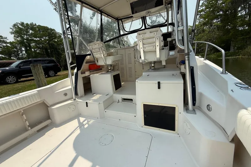 Slide: The Image of 1999 Grady-White Marlin 300 boat interior with seating and storage compartments. - 16