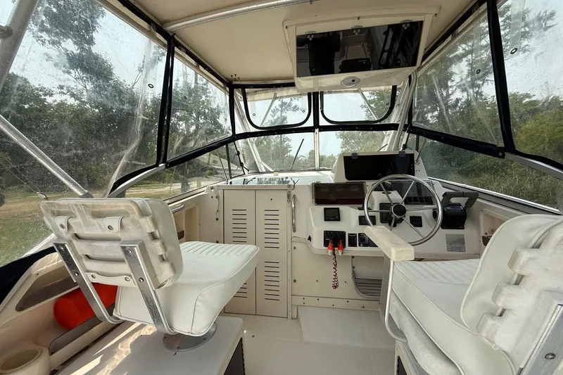 Slide: The Image of 1999 Grady-White Marlin 300 boat interior with steering wheel and seating. - 17