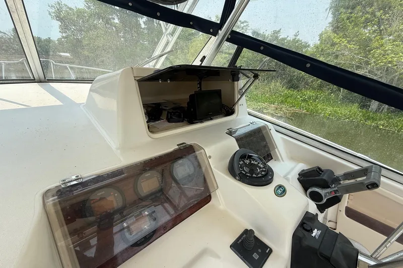 Slide: The Image of 1999 Grady-White Marlin 300 boat dashboard with navigation instruments and controls. - 19