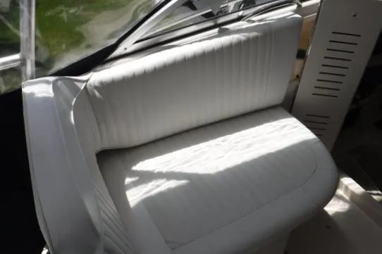 Slide: The Image of White seating on a 1999 Grady-White Marlin 300 boat, illuminated by sunlight. - 2