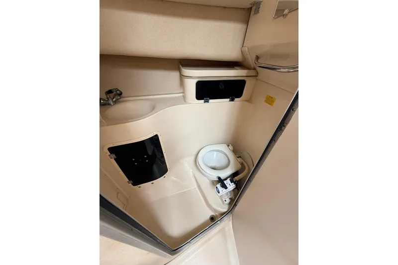 Slide: The Image of 1999 Grady-White Marlin 300 boat bathroom with toilet and sink. - 24