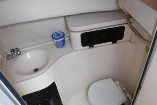 Slide: The Image of 1999 Grady-White Marlin 300 boat bathroom with sink and toilet. - 4