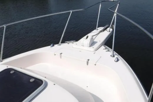 Slide: The Image of Bow of a 1999 Grady-White Marlin 300 boat on calm water. - 5