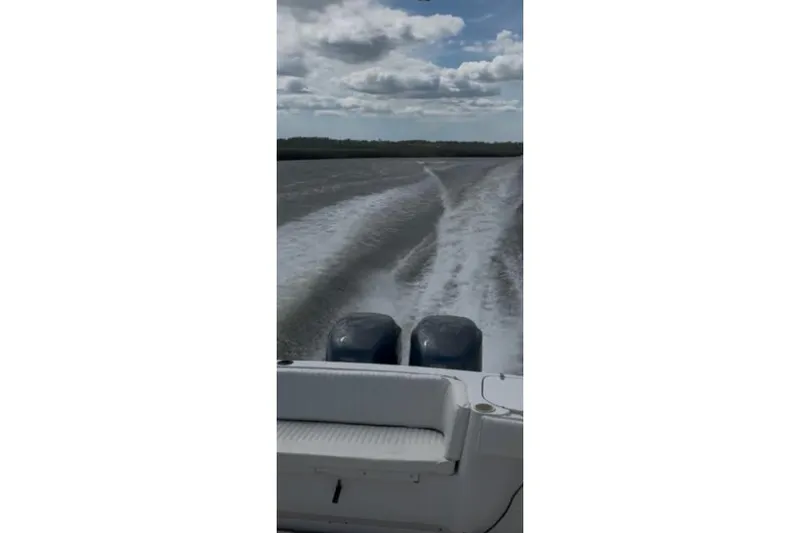 Slide: The Image of Grady-White Marlin 300 boat cruising on water, leaving a wake under a cloudy sky. - 6