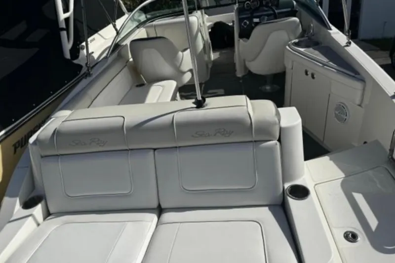 Slide: The Image of 2012 Sea Ray 260 Sundeck interior with white seating and helm. - 12