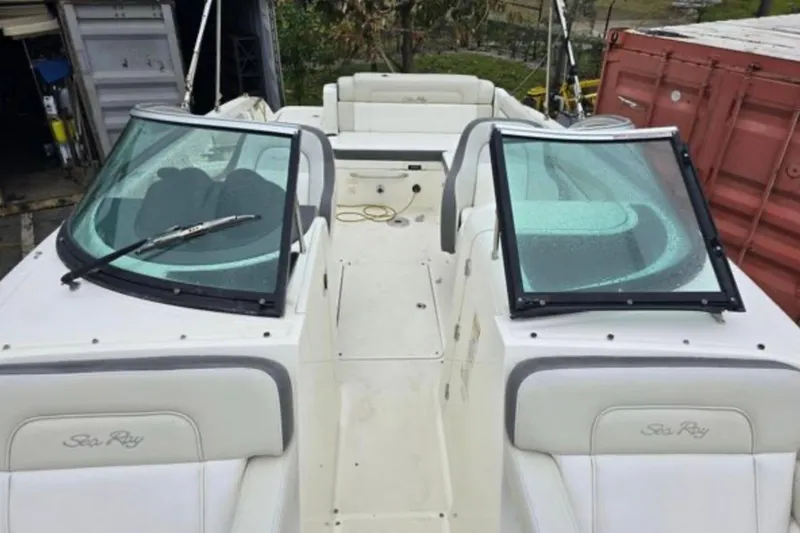 Slide: The Image of 2012 Sea Ray 260 Sundeck boat with dual windshields and white seating. - 3