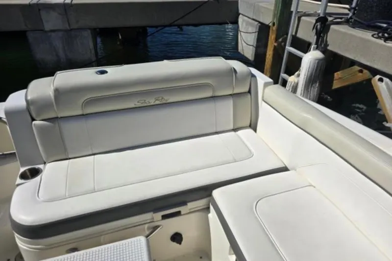 Slide: The Image of 2012 Sea Ray 260 Sundeck boat interior with white cushioned seating. - 5