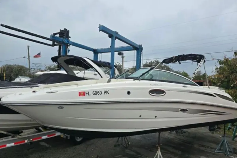 Slide: The Image of 2012 Sea Ray 260 Sundeck boat on trailer, displayed outdoors. - 6