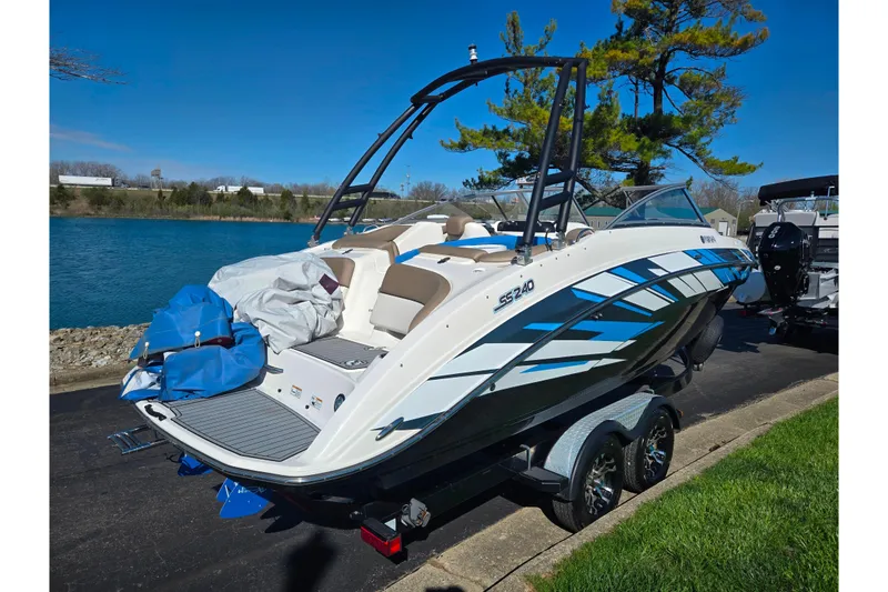 The Image of 2011 Yamaha Boats SX240 HO on trailer by a lake, ready for adventure. - 1