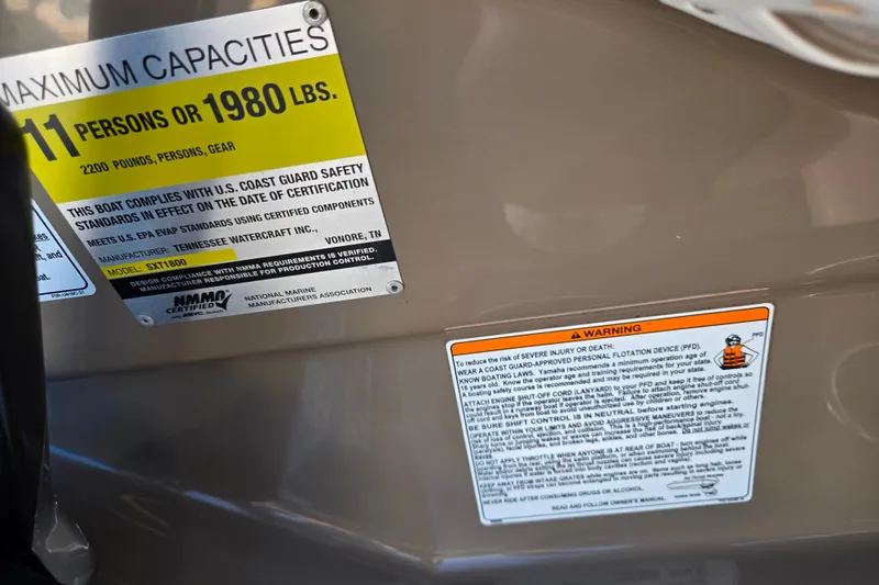 Slide: The Image of 2011 Yamaha Boats SX240 HO capacity and safety warning labels. - 12