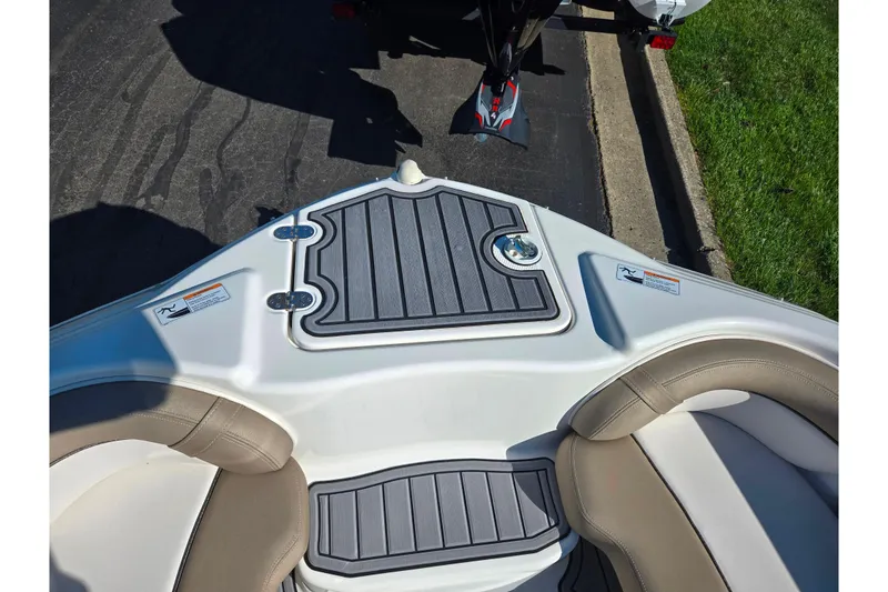 Slide: The Image of 2011 Yamaha Boats SX240 HO bow seating area with cushioned seats and non-slip flooring. - 18