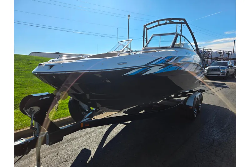 Slide: The Image of 2011 Yamaha Boats SX240 HO on trailer, parked outdoors under clear sky. - 5