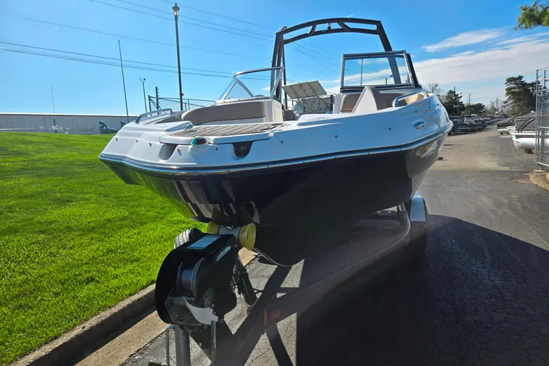Slide: The Image of 2011 Yamaha Boats SX240 HO on trailer, parked outdoors under clear blue sky. - 6