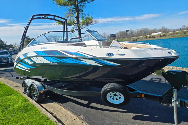 Slide: The Image of 2011 Yamaha Boats SX240 HO on trailer by a lake, sunny day. - 8