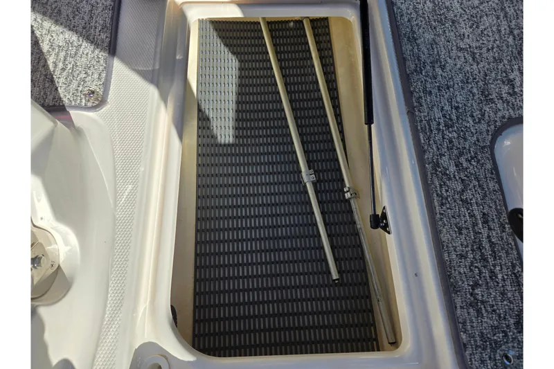 Slide: The Image of 2016 Chaparral Vortex 203 VRX storage compartment with textured flooring and support rods. - 14