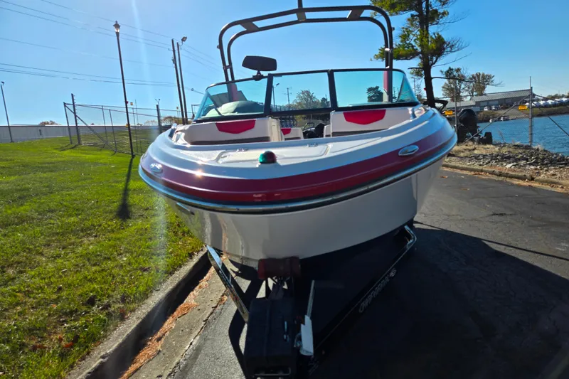 Slide: The Image of 2016 Chaparral Vortex 203 VRX boat on trailer, parked near water. - 6