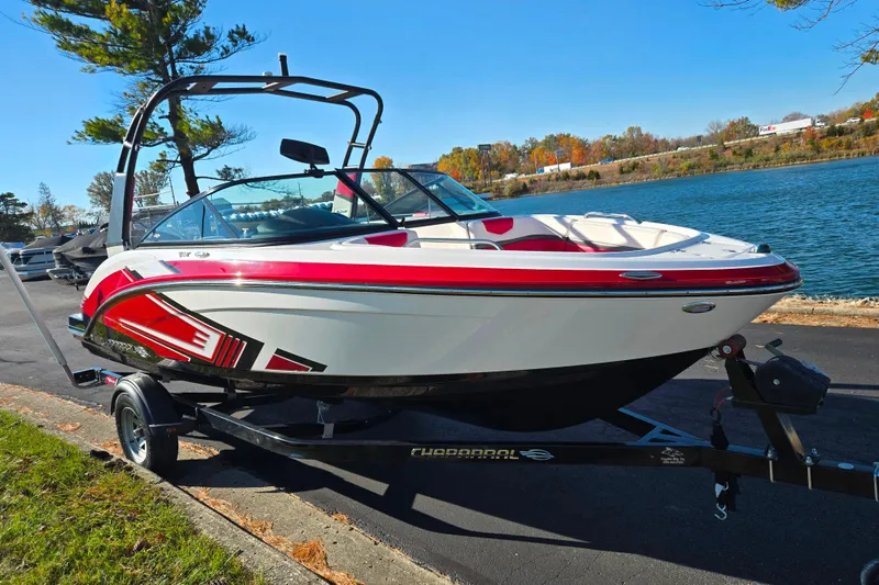 Slide: The Image of 2016 Chaparral Vortex 203 VRX boat on trailer by a lake, vibrant red accents. - 8