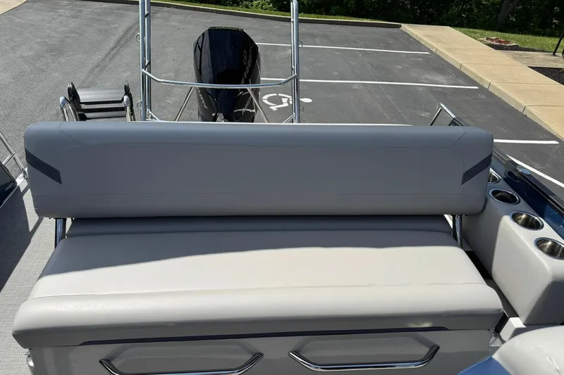 Slide: The Image of 2024 Crest Caribbean LX 230 boat with sleek seating and modern design in a parking lot. - 11