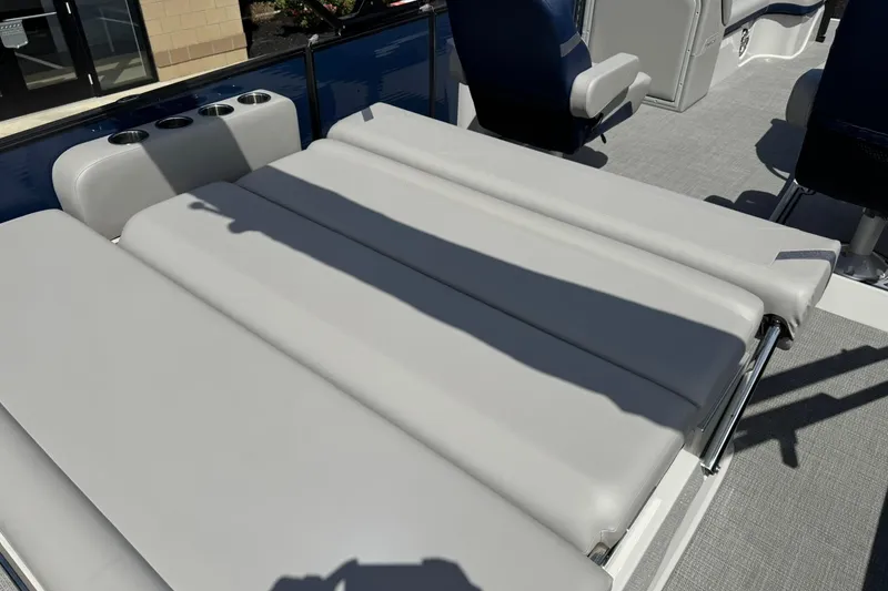 Slide: The Image of 2024 Crest Caribbean LX 230 boat with gray cushioned seating and cup holders. - 12