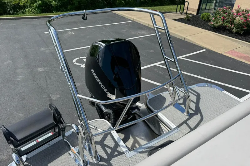 Slide: The Image of 2024 Crest Caribbean LX 230 boat with Mercury engine, parked in a lot. - 14