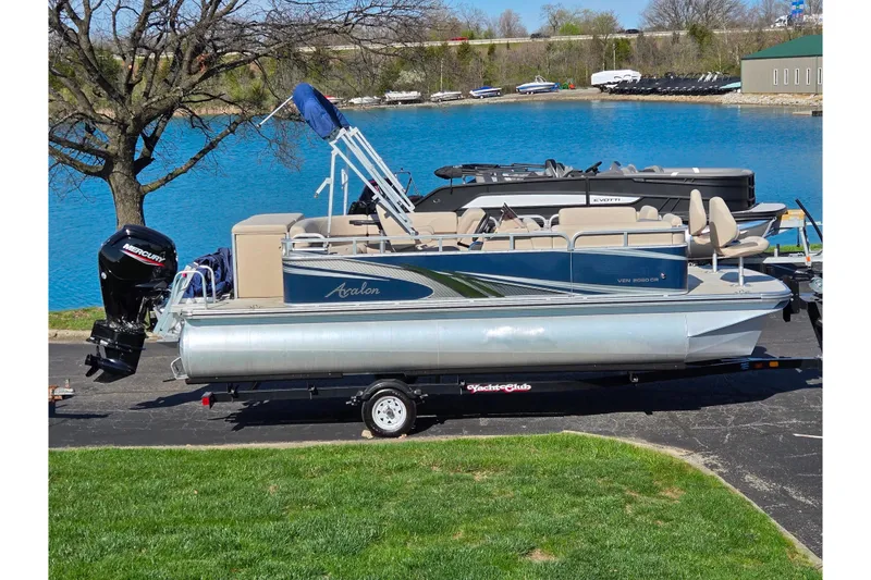 The Image of 2020 Avalon Venture Cruise Bow Fish pontoon boat on trailer by a lake. - 0
