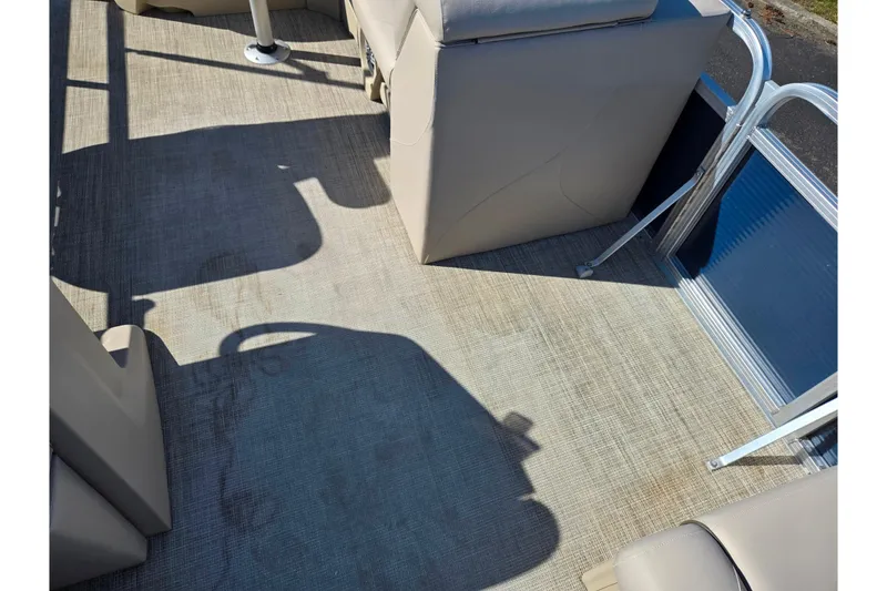 Slide: The Image of 2020 Avalon Venture Cruise Bow Fish boat interior with beige seating and flooring. - 13