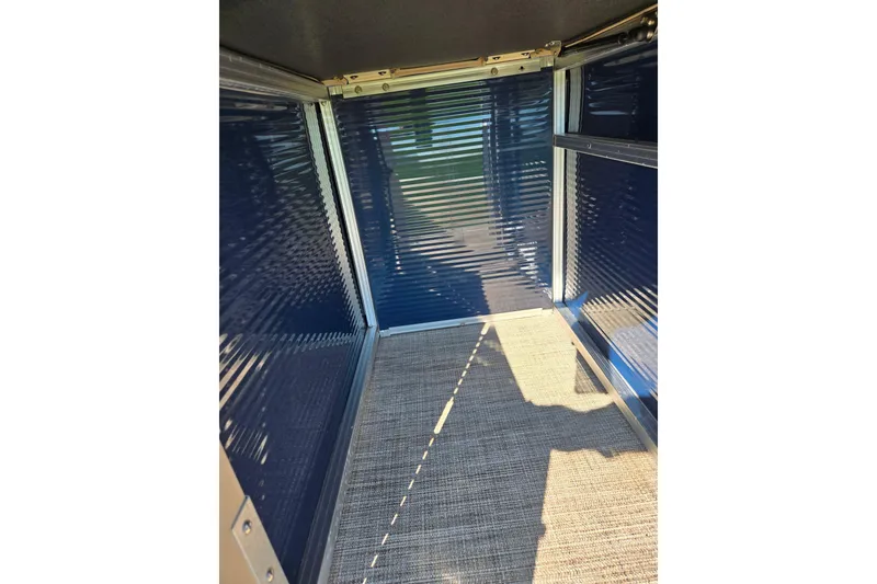 Slide: The Image of Interior view of 2020 Avalon Venture Cruise Bow Fish boat, featuring blue walls and carpeted floor. - 18