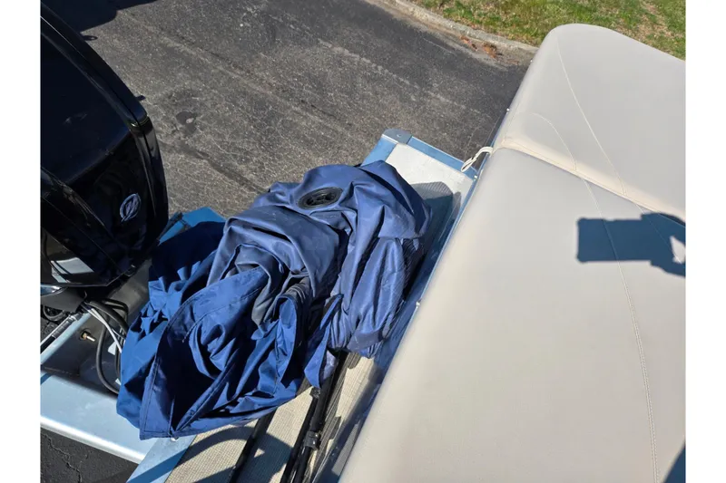 Slide: The Image of 2020 Avalon Venture Cruise Bow Fish boat with blue cover and beige seating. - 19