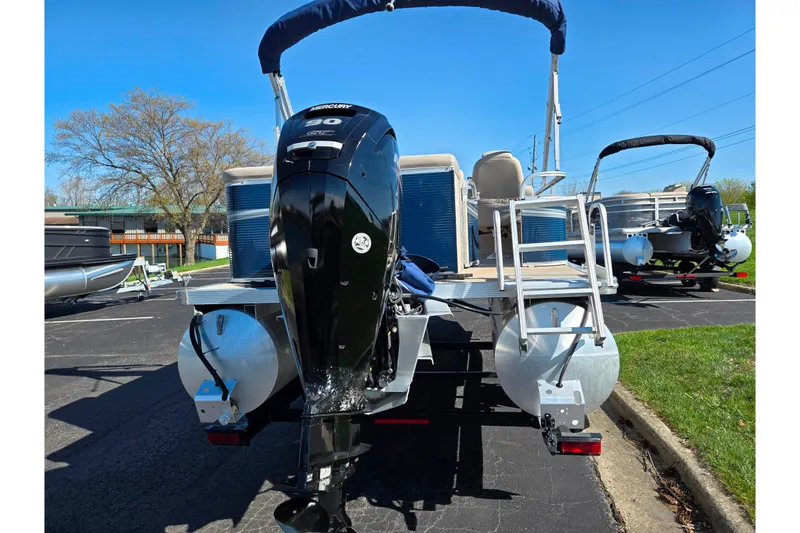 Slide: The Image of 2020 Avalon Venture Cruise Bow Fish pontoon boat with Mercury outboard motor, parked outdoors. - 2