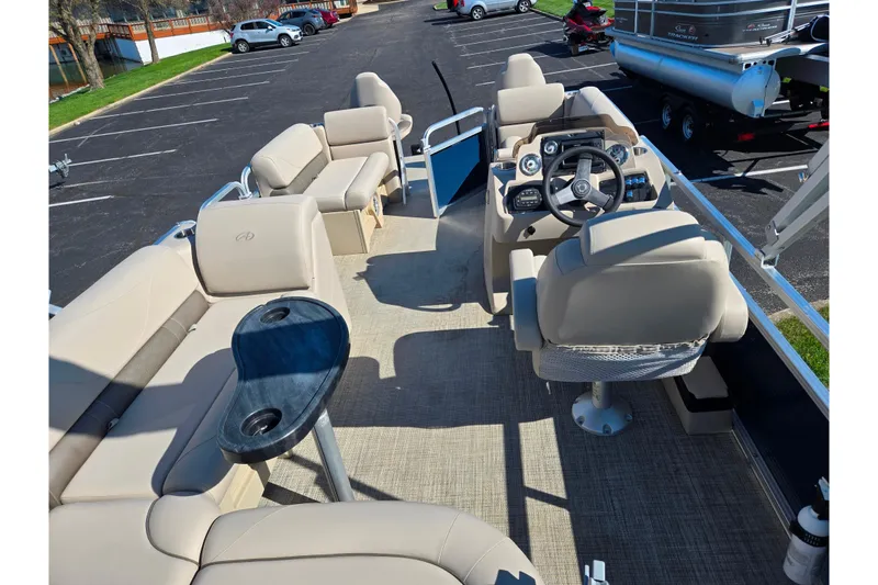 Slide: The Image of 2020 Avalon Venture Cruise Bow Fish boat interior with beige seating and steering console. - 21