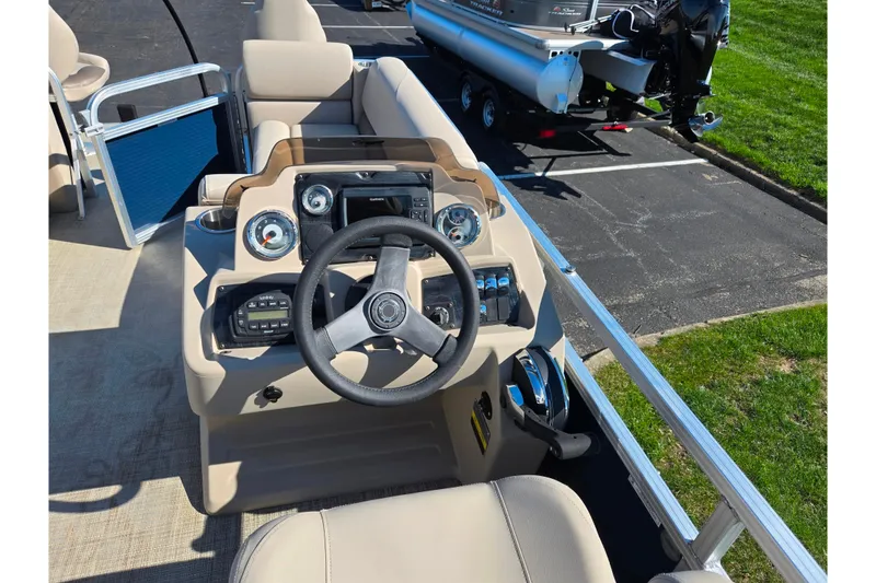 Slide: The Image of Cockpit view of 2020 Avalon Venture Cruise Bow Fish boat, featuring steering wheel and controls. - 22