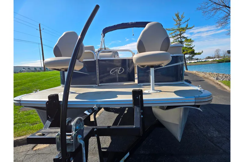 Slide: The Image of 2020 Avalon Venture Cruise Bow Fish pontoon boat on trailer by a lake. - 6