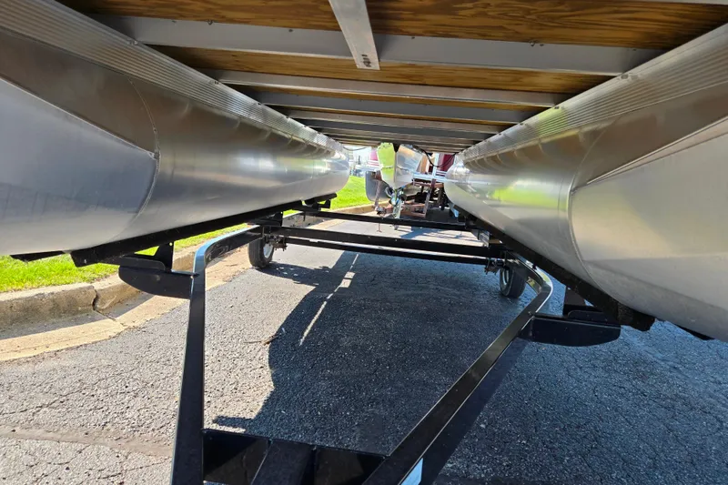 Slide: The Image of Underneath view of a 2020 Avalon Venture Cruise Bow Fish pontoon boat on a trailer. - 7