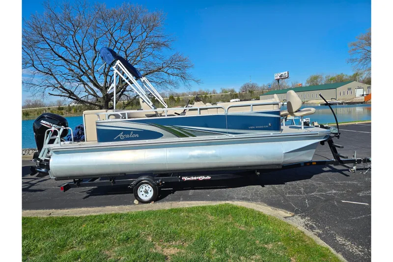 Slide: The Image of 2020 Avalon Venture Cruise Bow Fish pontoon boat on trailer by a lake. - 9