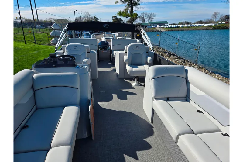 Slide: The Image of 2022 Crest Classic LX 220 SLRC pontoon boat with spacious seating and modern design. - 11