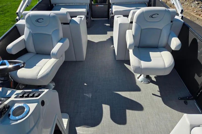 Slide: The Image of 2022 Crest Classic LX 220 SLRC boat interior with plush seating and modern helm. - 13