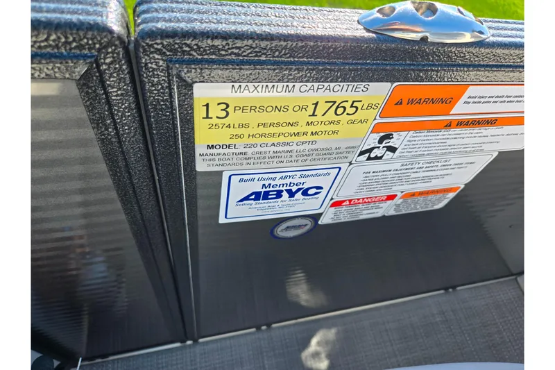 Slide: The Image of Capacity label on 2022 Crest Classic LX 220 SLRC boat, showing weight and passenger limits. - 15