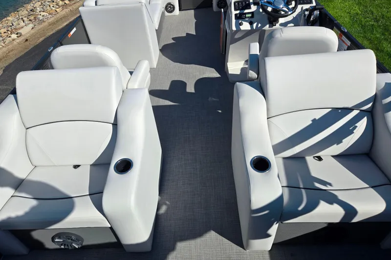 Slide: The Image of 2022 Crest Classic LX 220 SLRC boat interior with plush seating and cup holders. - 18