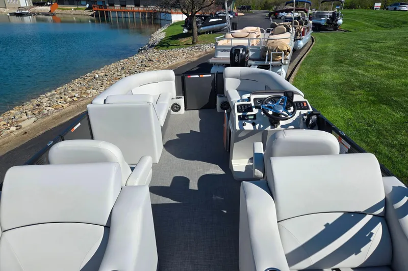 Slide: The Image of 2022 Crest Classic LX 220 SLRC pontoon boat with luxurious seating and modern controls. - 19