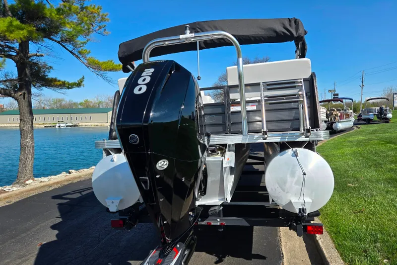Slide: The Image of 2022 Crest Classic LX 220 SLRC pontoon boat with powerful 200 HP engine by a lakeside. - 2