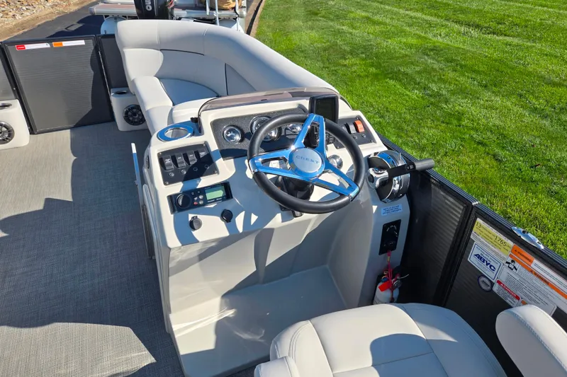 Slide: The Image of 2022 Crest Classic LX 220 SLRC boat interior with steering console and seating. - 20