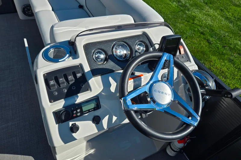 Slide: The Image of Steering console of 2022 Crest Classic LX 220 SLRC boat with modern controls. - 21