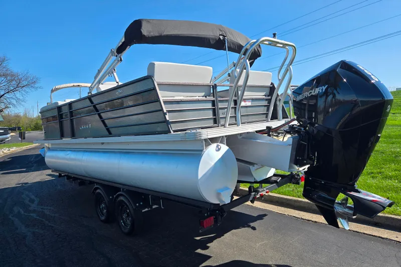 Slide: The Image of 2022 Crest Classic LX 220 SLRC pontoon boat with Mercury engine on trailer. - 3