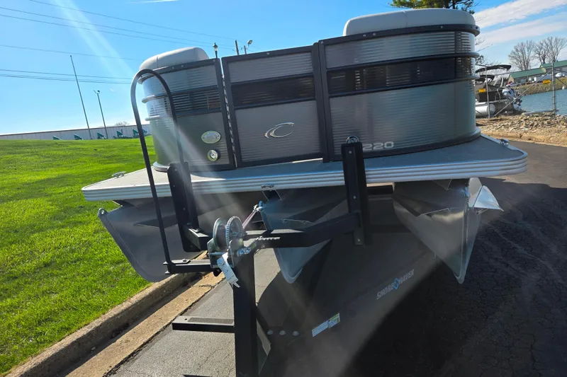 Slide: The Image of 2022 Crest Classic LX 220 SLRC pontoon boat on trailer, sunny day. - 6