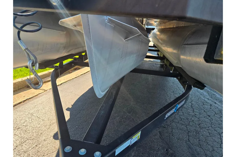 Slide: The Image of Underneath view of a 2022 Crest Classic LX 220 SLRC pontoon boat on a trailer. - 7