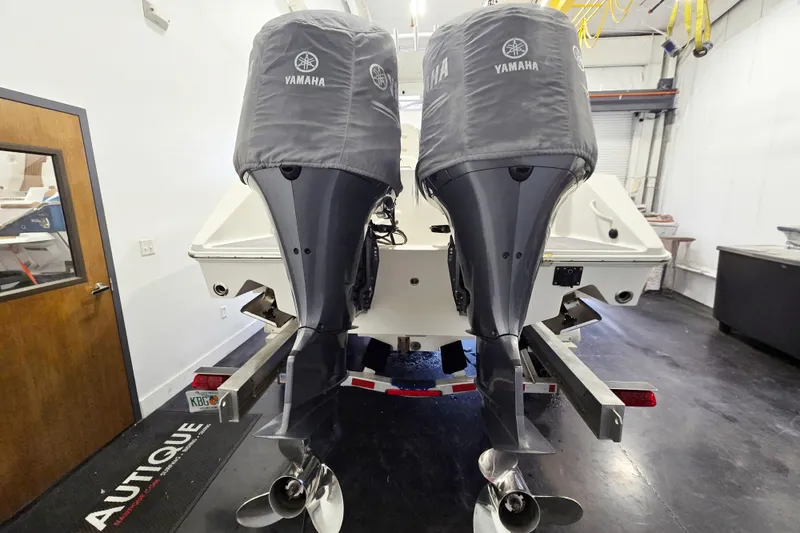 Slide: The Image of 2017 Jupiter 30 HFS boat with twin Yamaha outboard motors in a garage. - 12