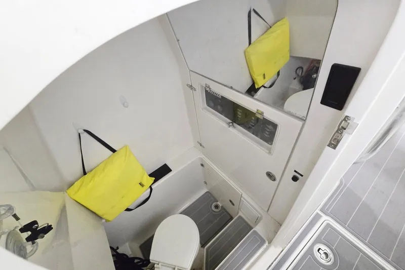 Slide: The Image of Interior of 2017 Jupiter 30 HFS boat, featuring compact bathroom with yellow bag. - 5