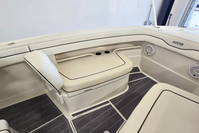 Slide: The Image of 2017 Jupiter 30 HFS boat interior with cushioned seating and speakers. - 8